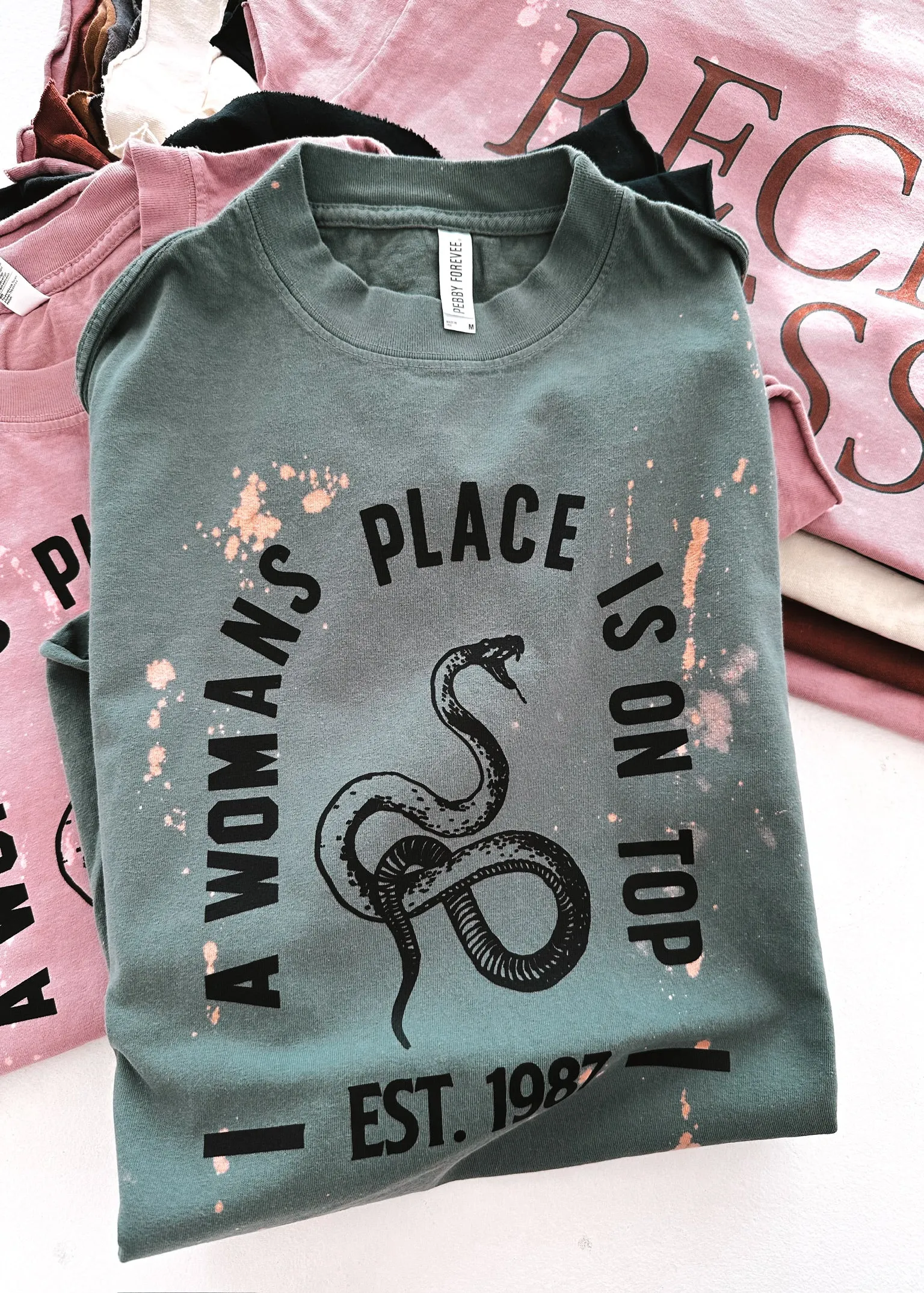 A WOMAN'S PLACE IS ON TOP BLEACHED OUT SIDE SLIT TEE